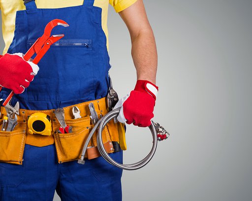plumber with tool belt isolated on gray